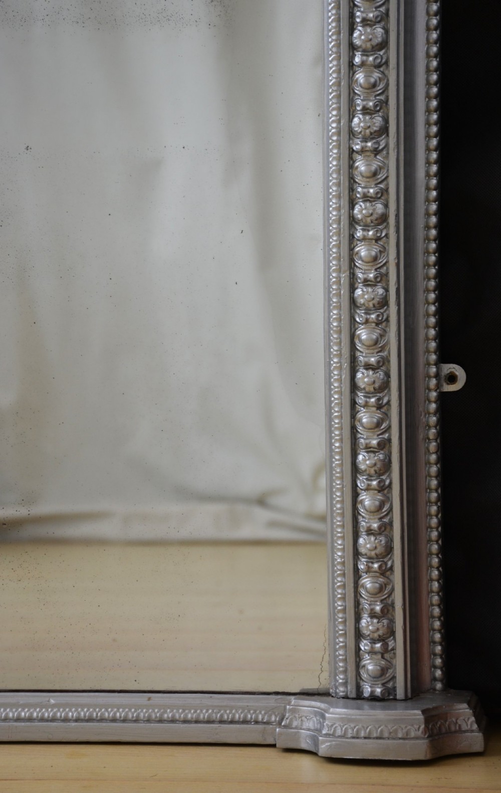 An arched Victorian silver-gilded overmantel mirror featuring beaded edge moulding along the frame. View VII