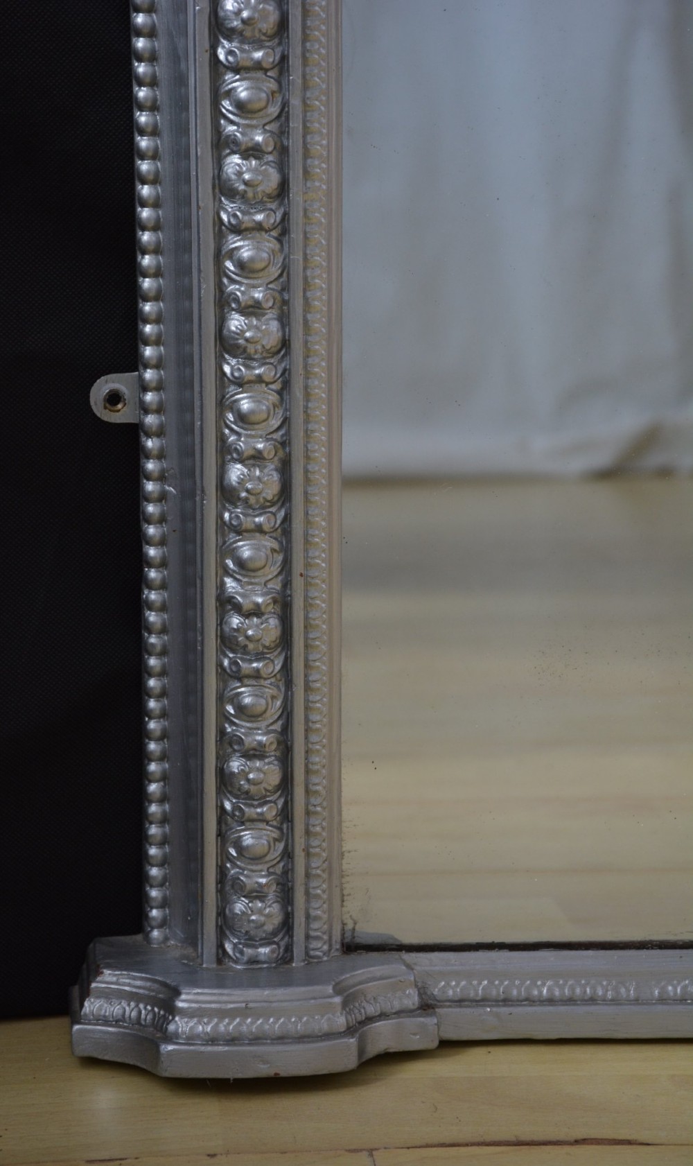 An arched Victorian silver-gilded overmantel mirror featuring beaded edge moulding along the frame. View X