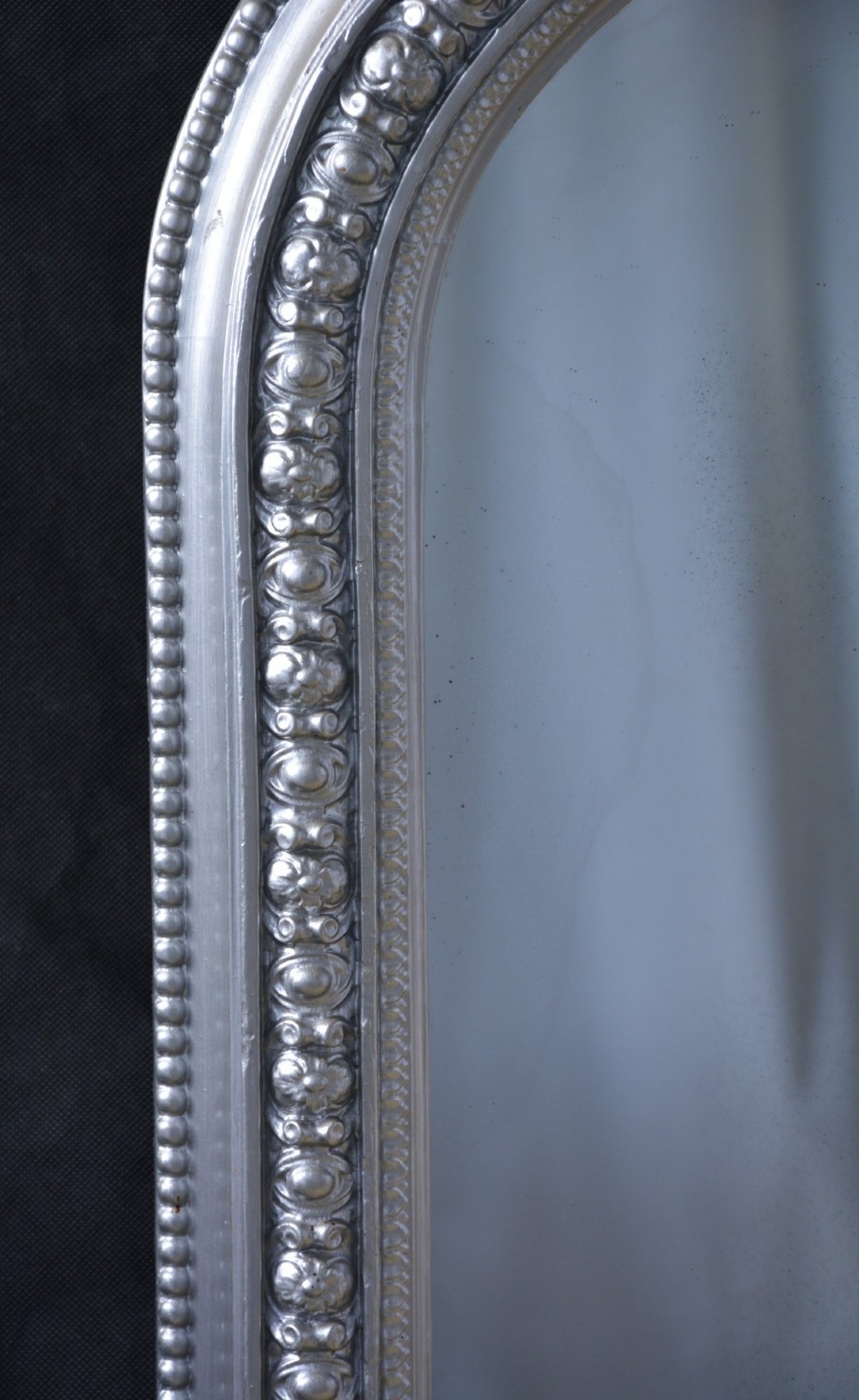 An arched Victorian silver-gilded overmantel mirror featuring beaded edge moulding along the frame. View XI