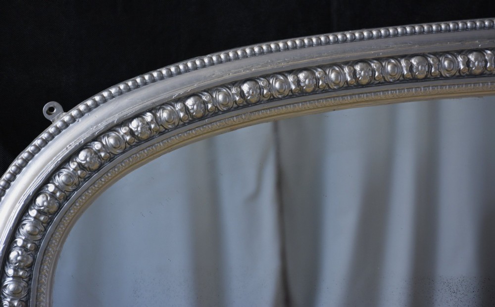An arched Victorian silver-gilded overmantel mirror featuring beaded edge moulding along the frame. View XIII