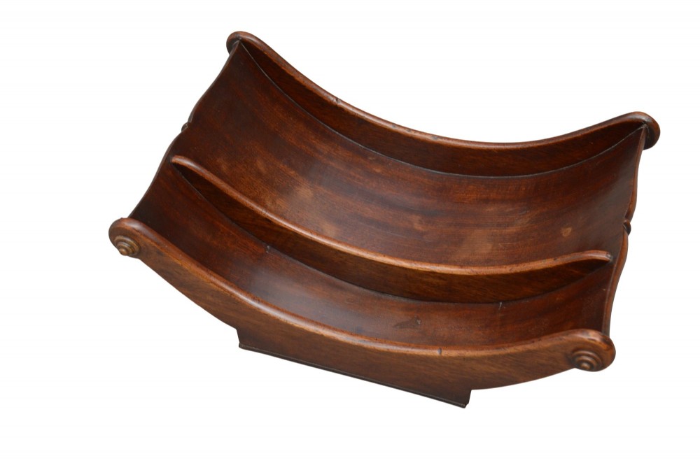 A Georgian mahogany cheese coaster displaying a crescent-shaped wooden body with carved scroll terminals and a central dividing partition. View III