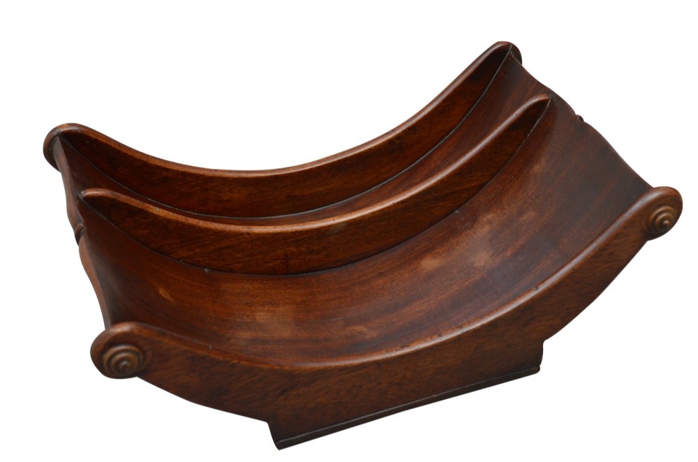 A Georgian mahogany cheese coaster displaying a crescent-shaped wooden body with carved scroll terminals and a central dividing partition. View IV