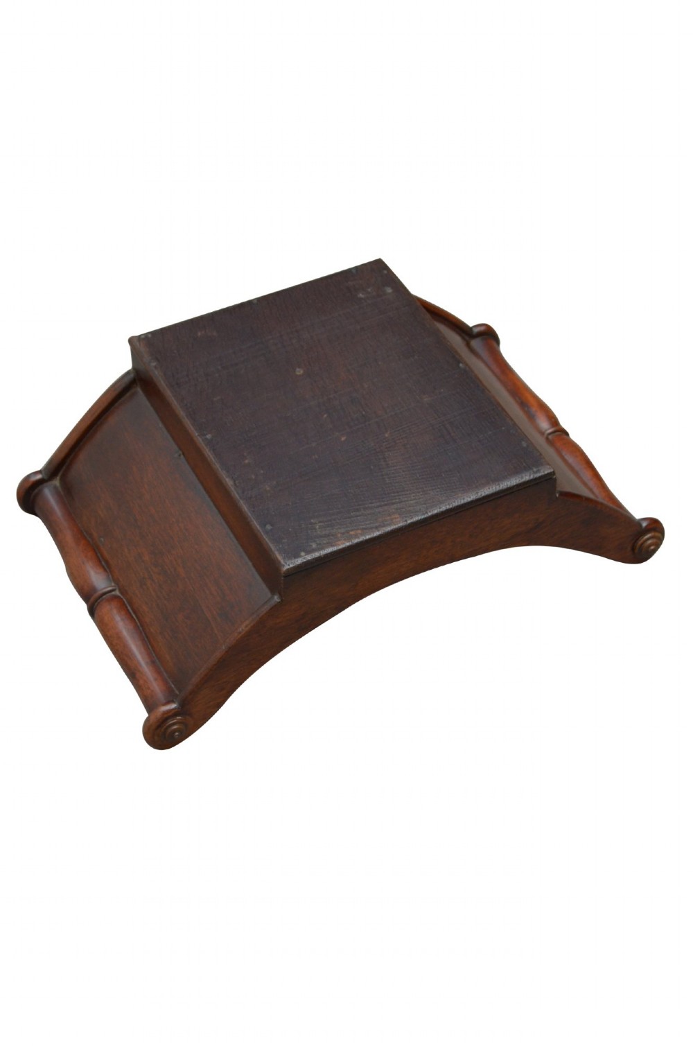 A Georgian mahogany cheese coaster displaying a crescent-shaped wooden body with carved scroll terminals and a central dividing partition. View VIII