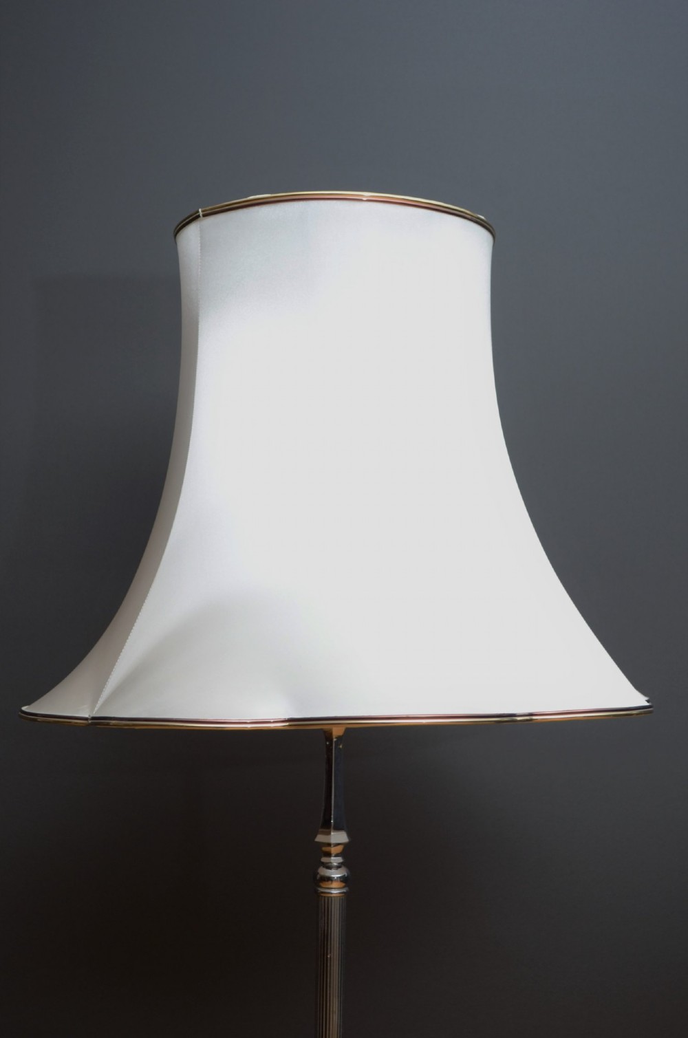 An Art Deco metal standard lamp featuring a fluted central stem, tripod sweeping base supports, and a scalloped white fabric shade. View IX