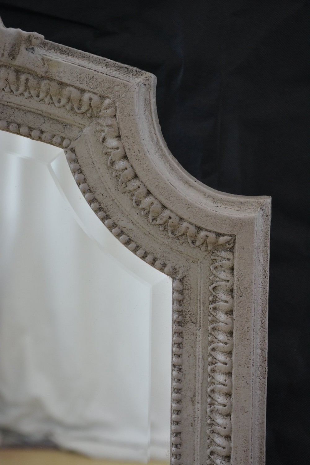 A tall grey-painted French Rococo style wall mirror featuring a carved ribbon top crest and scroll detailing. View III