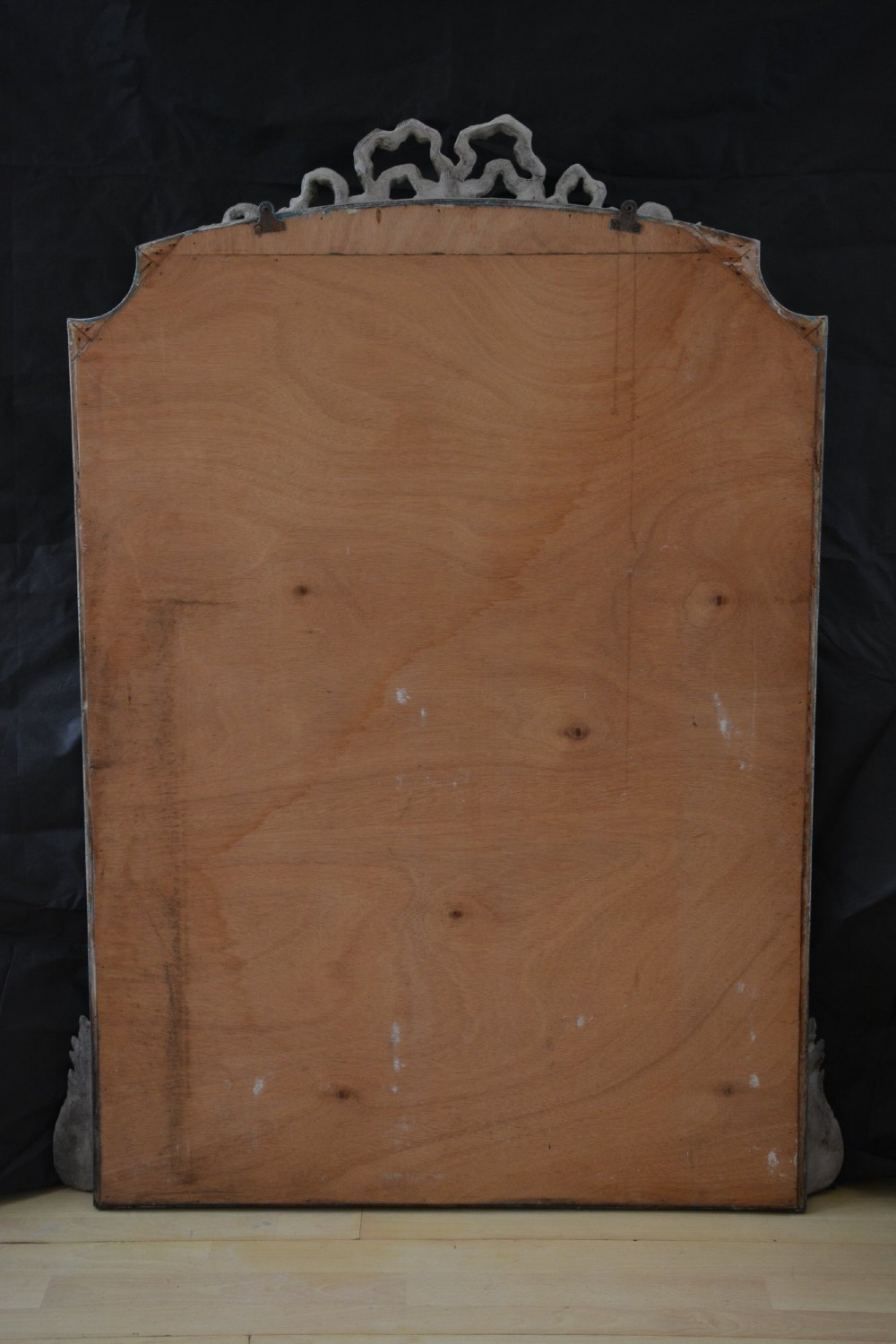A tall grey-painted French Rococo style wall mirror featuring a carved ribbon top crest and scroll detailing. View VI