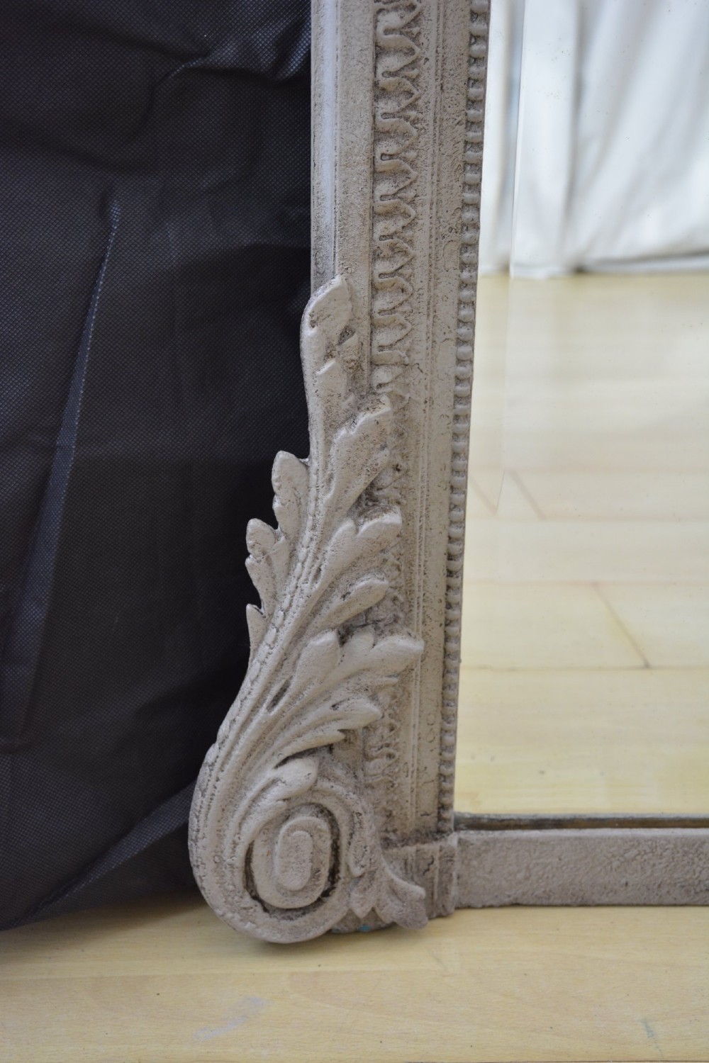 A tall grey-painted French Rococo style wall mirror featuring a carved ribbon top crest and scroll detailing. View VIII