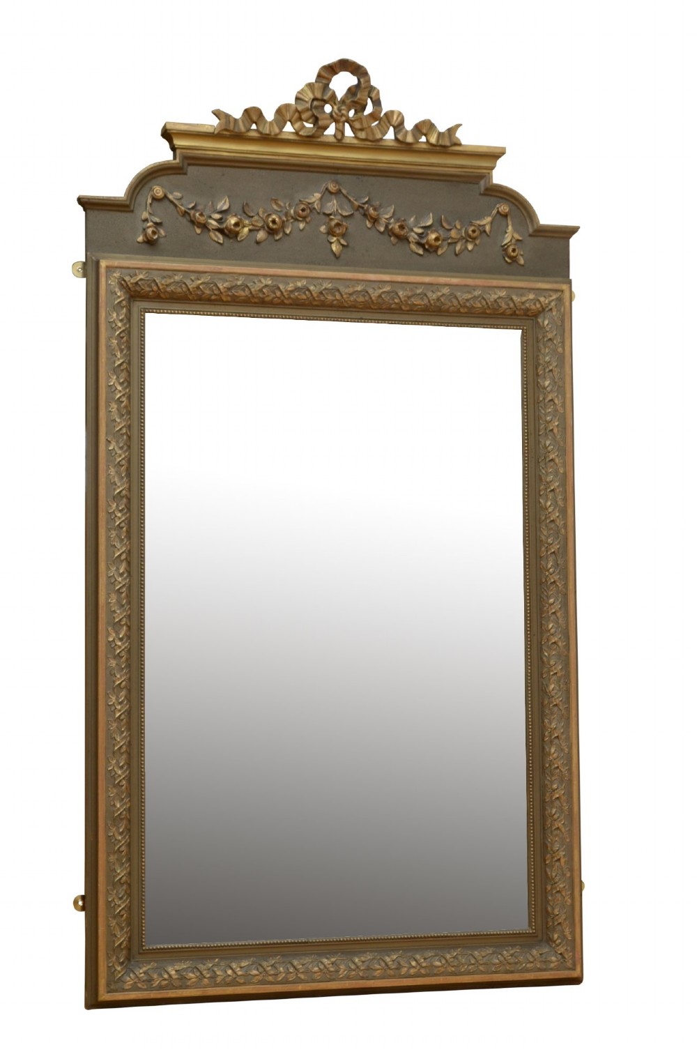 A tall antique French pier mirror featuring a gilded ribbon cresting, carved floral swags, and leaf moulding framing rectangular mirror glass.
