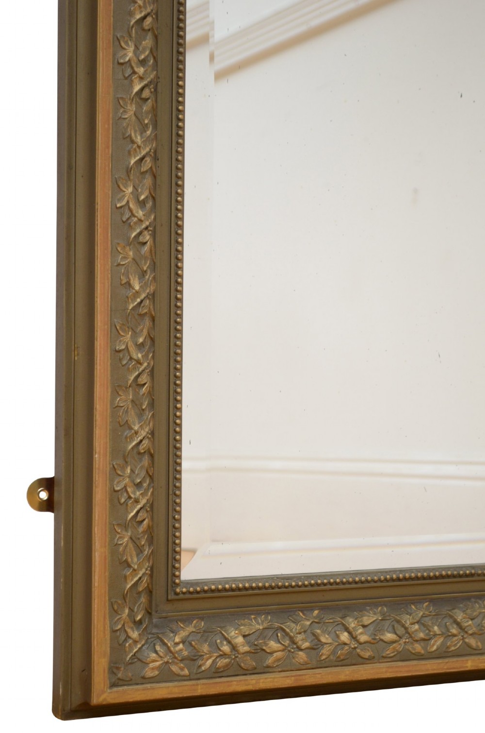 A tall antique French pier mirror featuring a gilded ribbon cresting, carved floral swags, and leaf moulding framing rectangular mirror glass. View XI