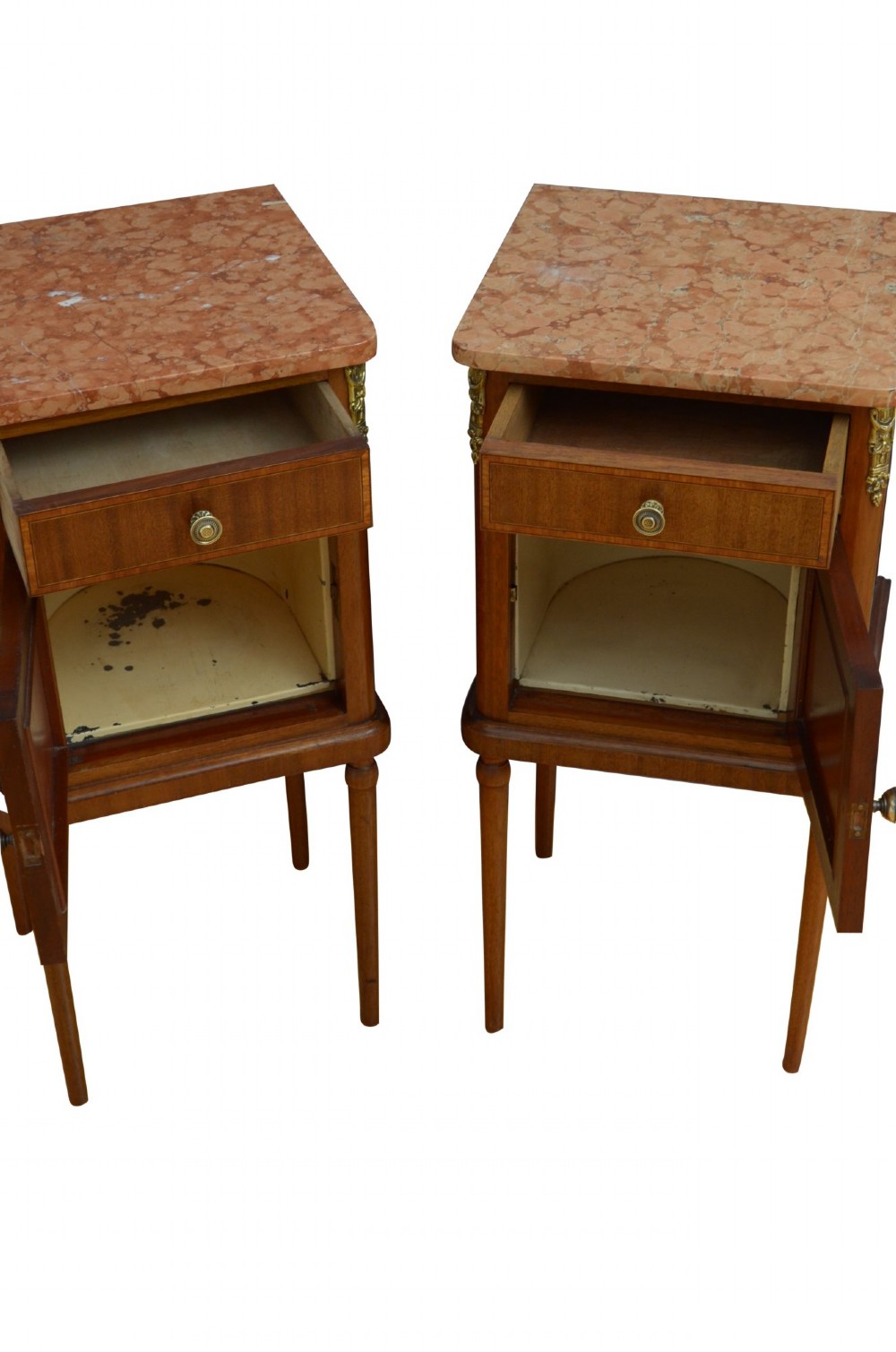 A pair of tall French Louis XVI style wooden bedside cabinets featuring pink marble tops, single drawers, cupboard doors with sunburst parquetry motifs, and slender turned legs. View II