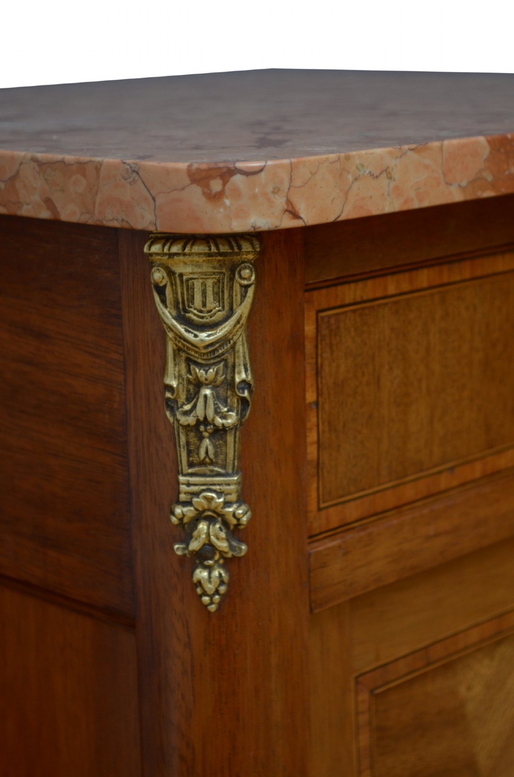 A pair of tall French Louis XVI style wooden bedside cabinets featuring pink marble tops, single drawers, cupboard doors with sunburst parquetry motifs, and slender turned legs. View IV