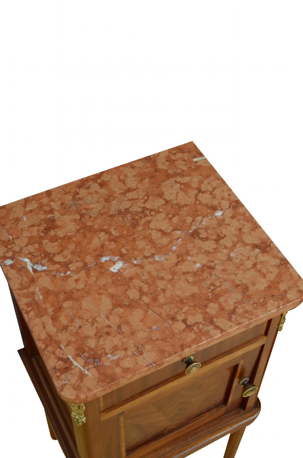 A pair of tall French Louis XVI style wooden bedside cabinets featuring pink marble tops, single drawers, cupboard doors with sunburst parquetry motifs, and slender turned legs. View IX