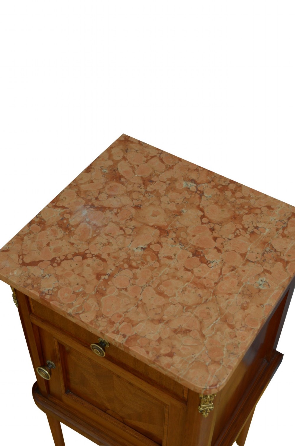 A pair of tall French Louis XVI style wooden bedside cabinets featuring pink marble tops, single drawers, cupboard doors with sunburst parquetry motifs, and slender turned legs. View X
