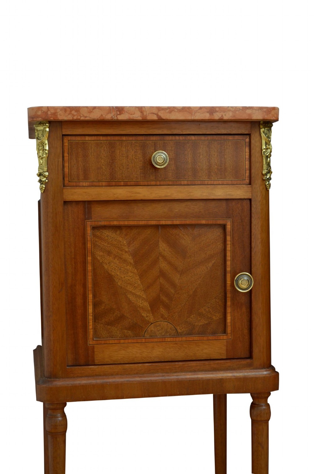 A pair of tall French Louis XVI style wooden bedside cabinets featuring pink marble tops, single drawers, cupboard doors with sunburst parquetry motifs, and slender turned legs. View XI