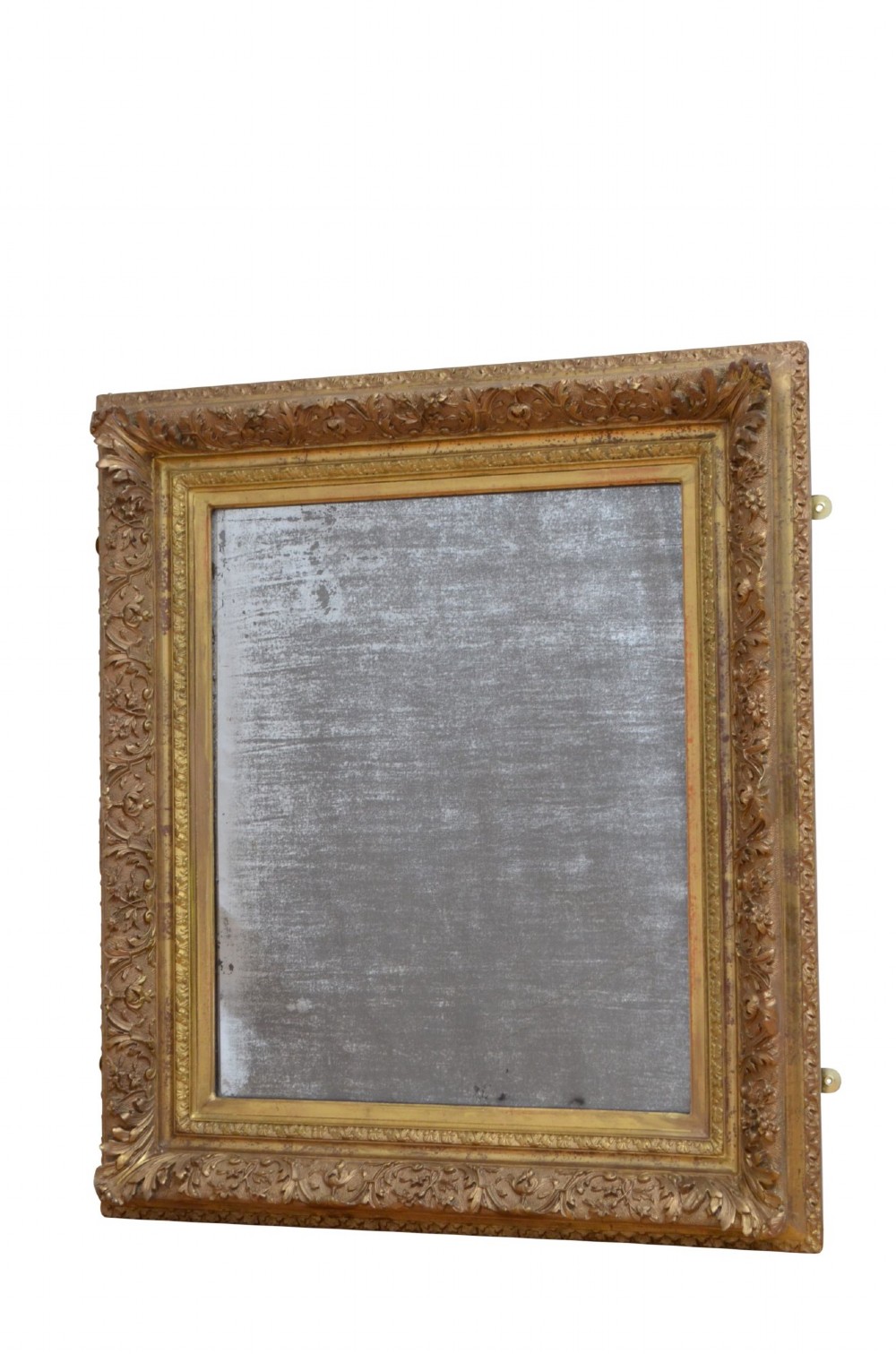 A rectangular antique Rococo giltwood wall mirror featuring carved acanthus foliage mouldings around a heavily foxed mirror glass pane. View III