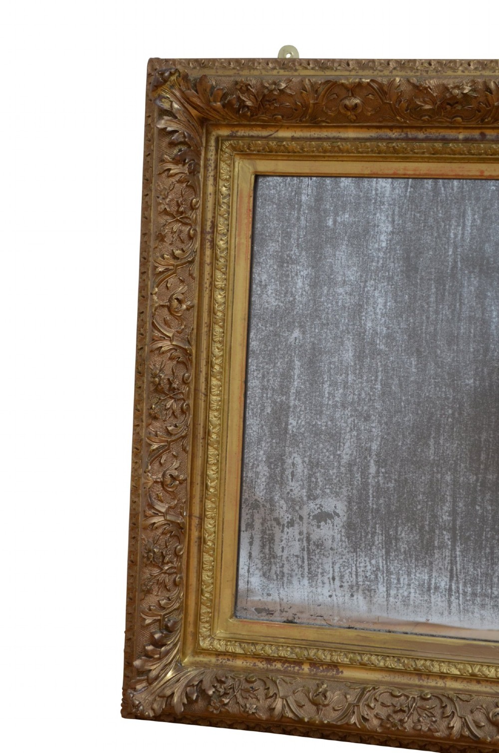 A rectangular antique Rococo giltwood wall mirror featuring carved acanthus foliage mouldings around a heavily foxed mirror glass pane. View IV