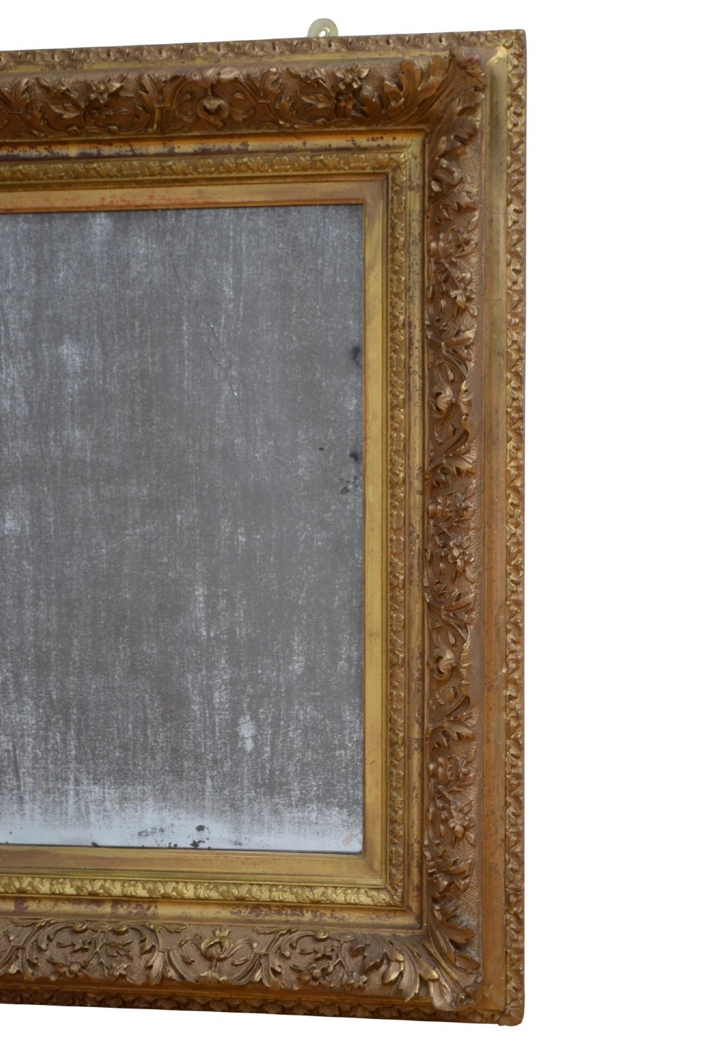 A rectangular antique Rococo giltwood wall mirror featuring carved acanthus foliage mouldings around a heavily foxed mirror glass pane. View VI