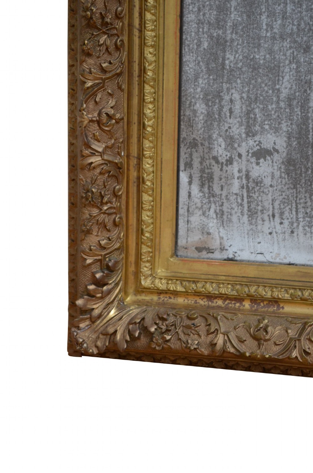 A rectangular antique Rococo giltwood wall mirror featuring carved acanthus foliage mouldings around a heavily foxed mirror glass pane. View VIII