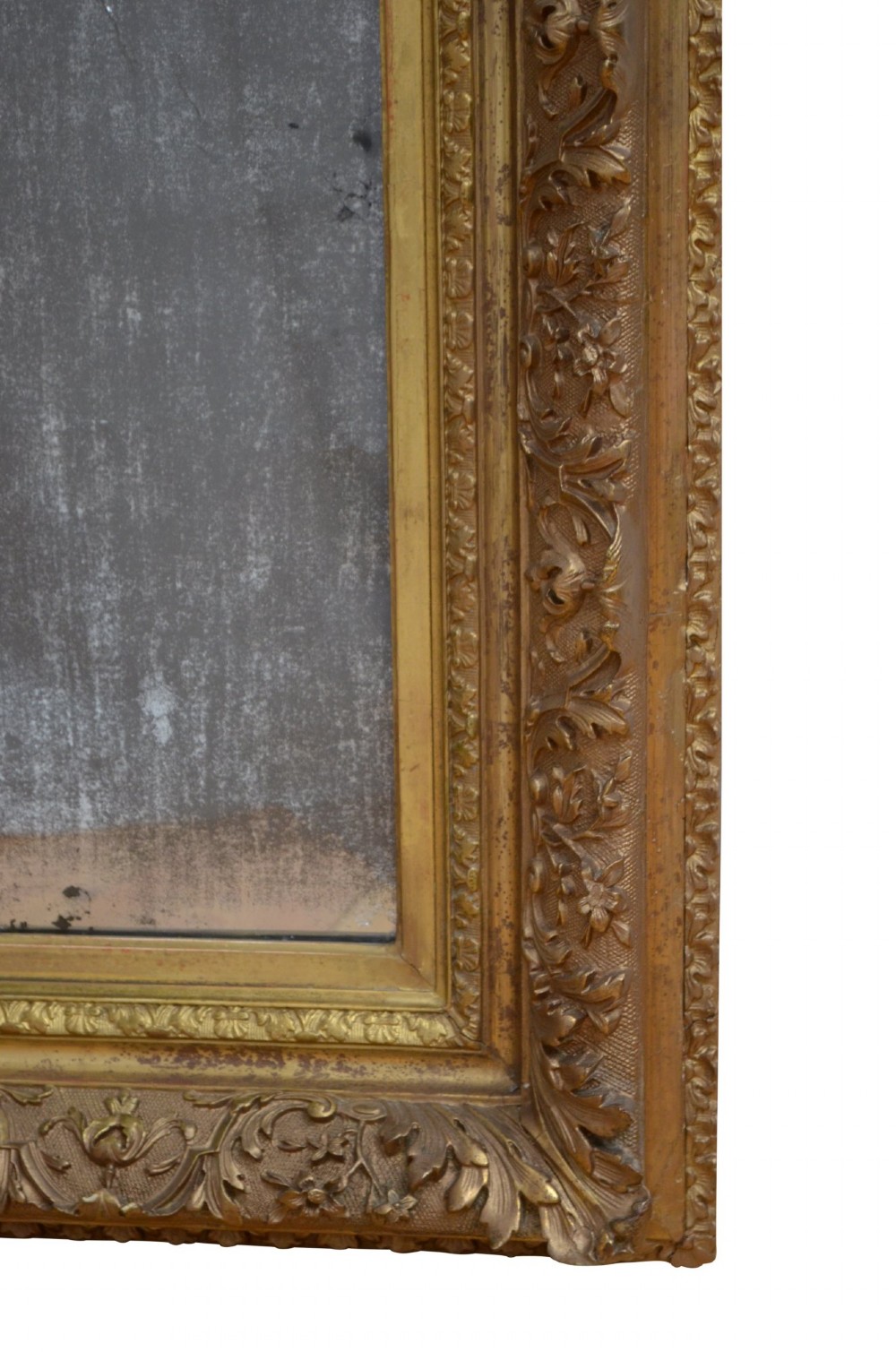 A rectangular antique Rococo giltwood wall mirror featuring carved acanthus foliage mouldings around a heavily foxed mirror glass pane. View XI