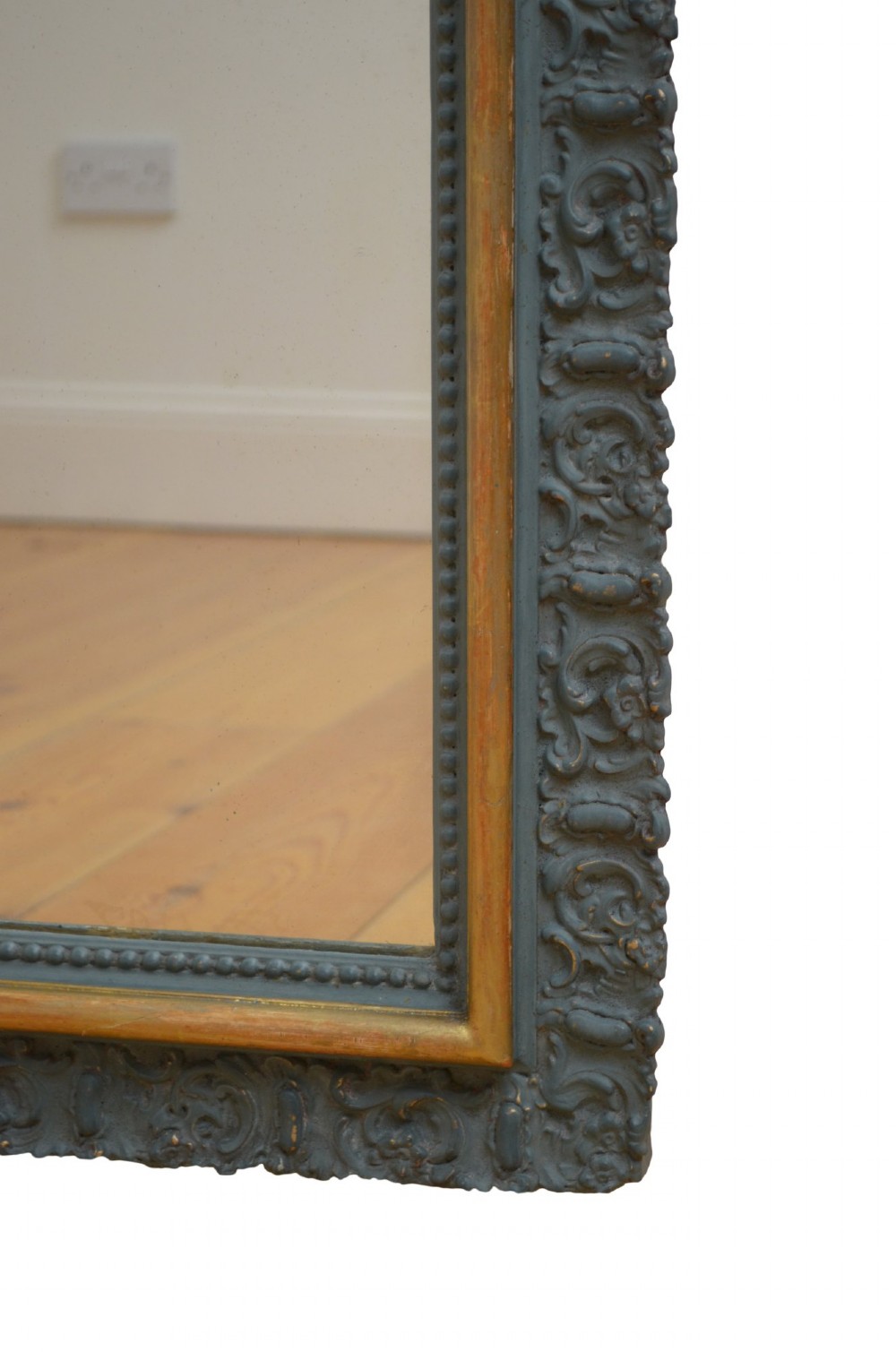 A tall rectangular wall mirror featuring a dark grey carved frame with a golden inner bead and an intricate foliage crest at the top. View II