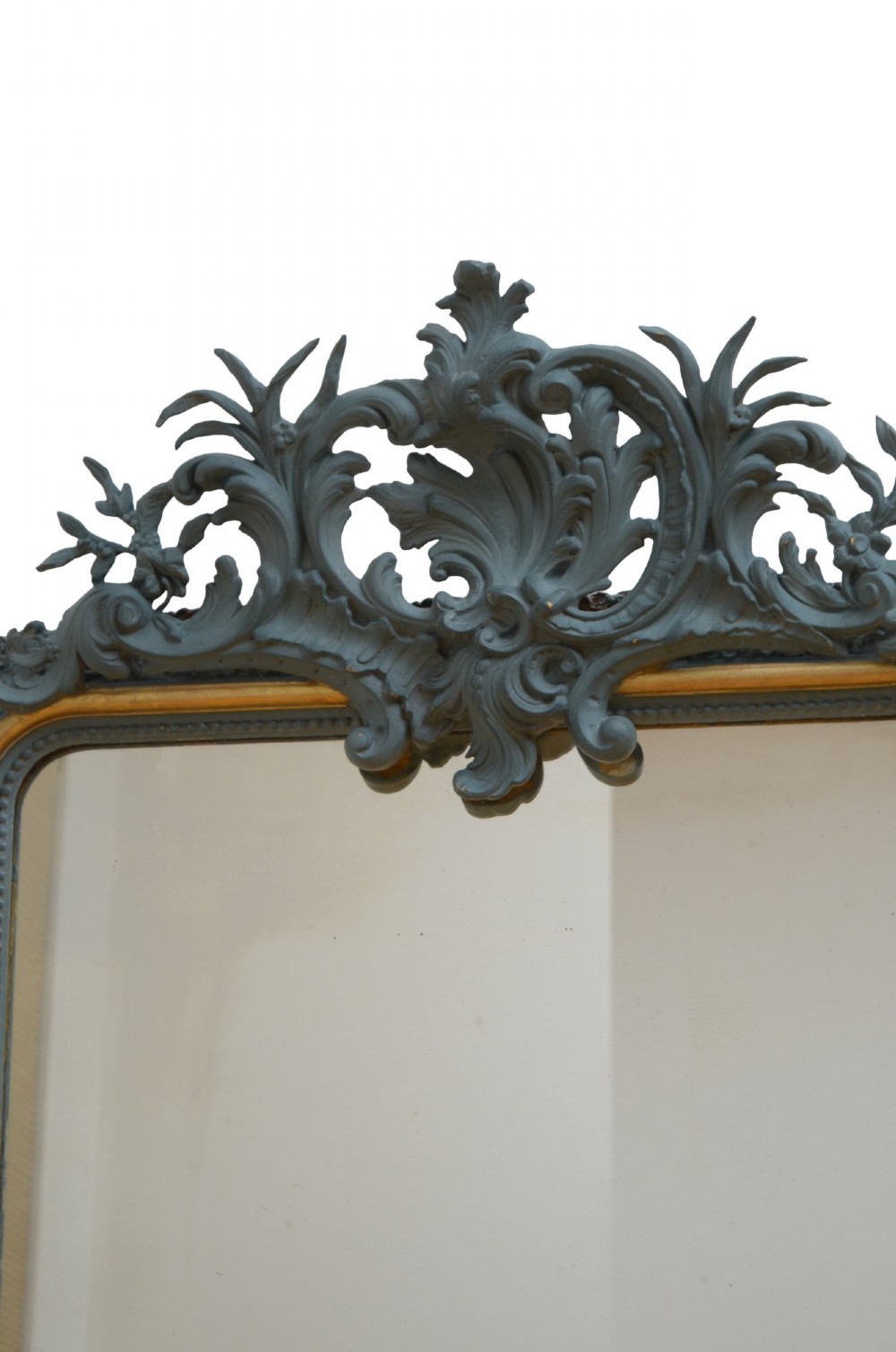 A tall rectangular wall mirror featuring a dark grey carved frame with a golden inner bead and an intricate foliage crest at the top. View VIII