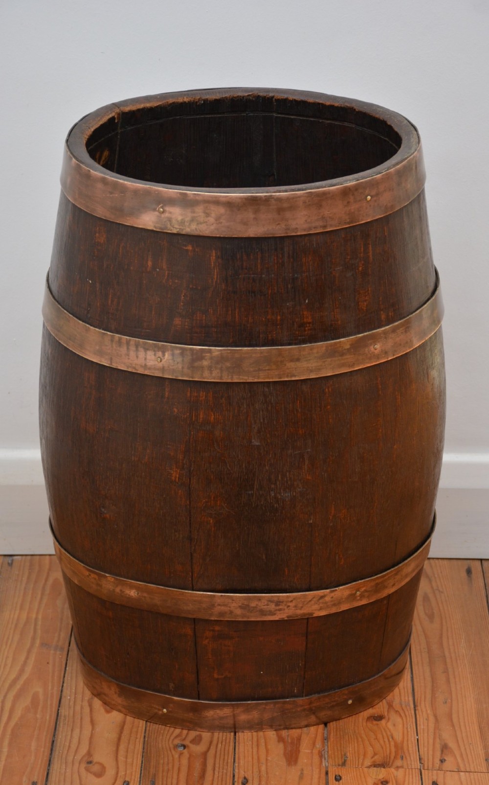 A Victorian dark oak coopered barrel umbrella stand with polished metal binding hoops. View II