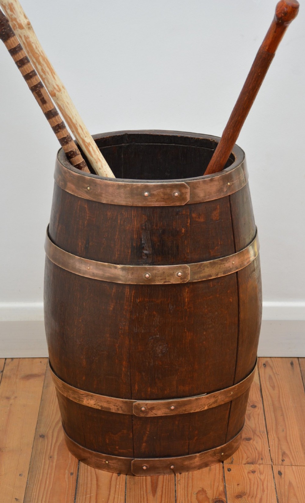 A Victorian dark oak coopered barrel umbrella stand with polished metal binding hoops. View III