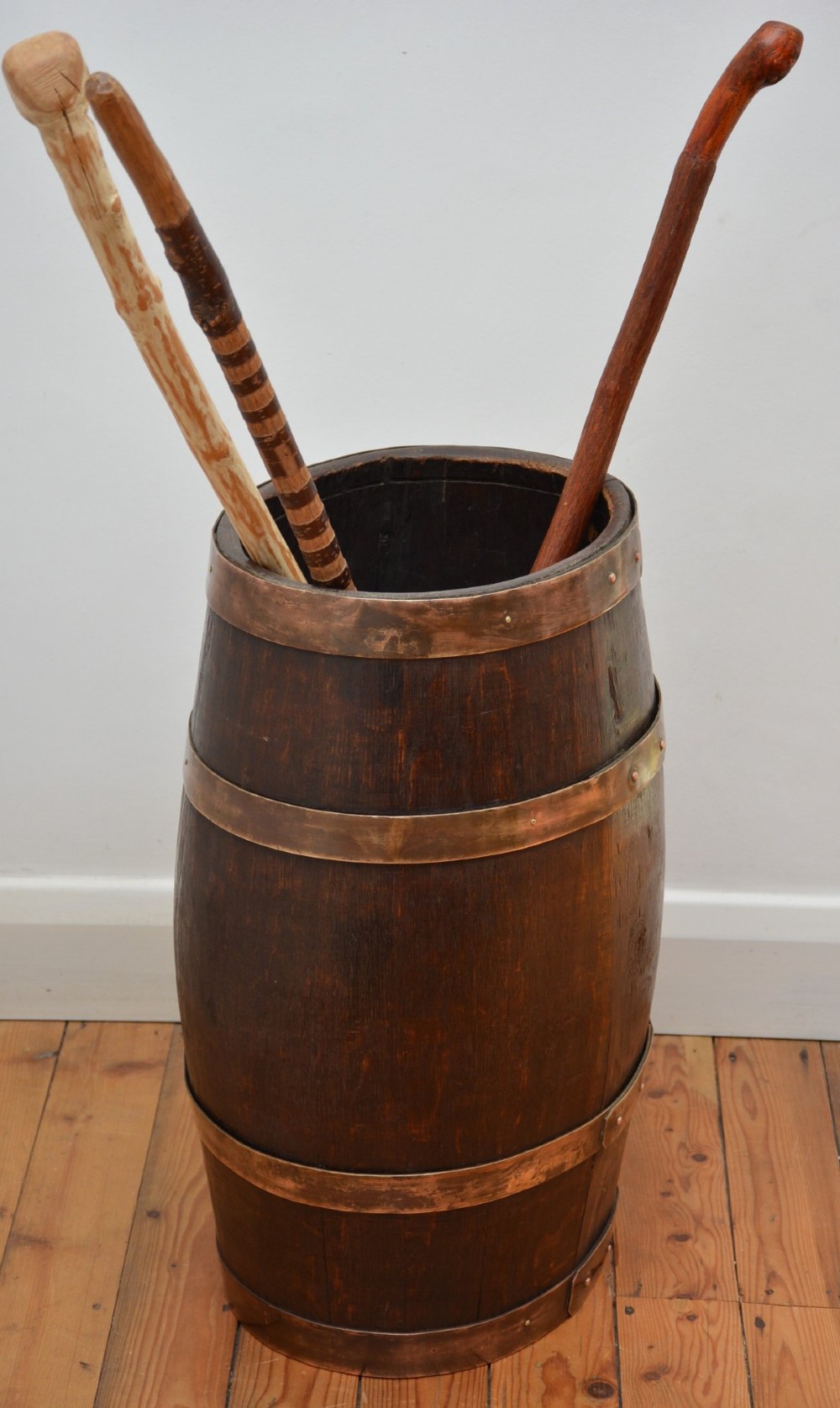 A Victorian dark oak coopered barrel umbrella stand with polished metal binding hoops. View IV