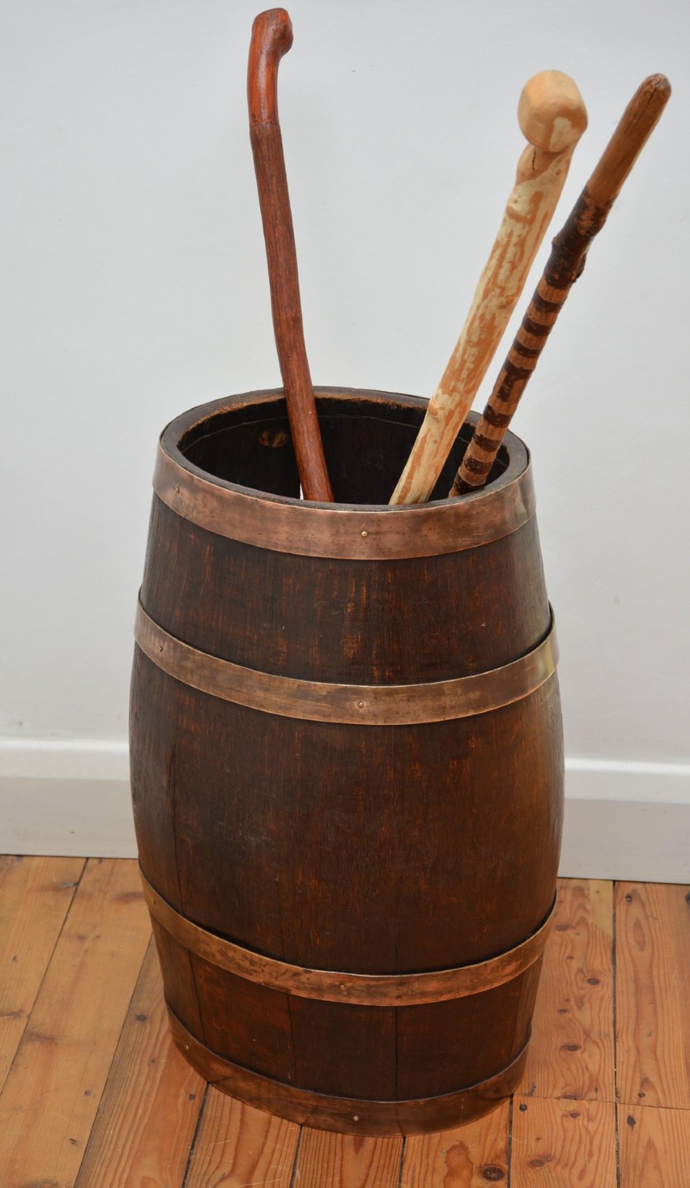 A Victorian dark oak coopered barrel umbrella stand with polished metal binding hoops. View V