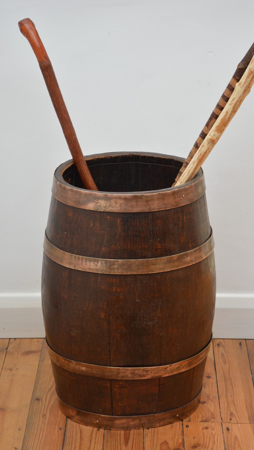 A Victorian dark oak coopered barrel umbrella stand with polished metal binding hoops. View VI