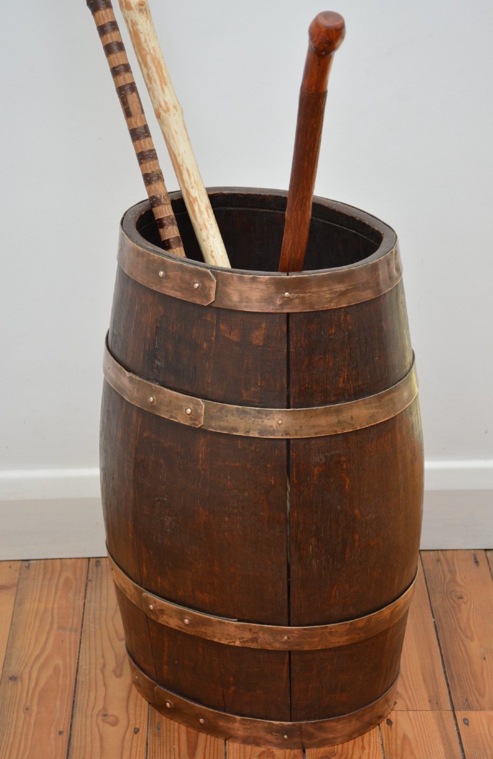 A Victorian dark oak coopered barrel umbrella stand with polished metal binding hoops. View VII