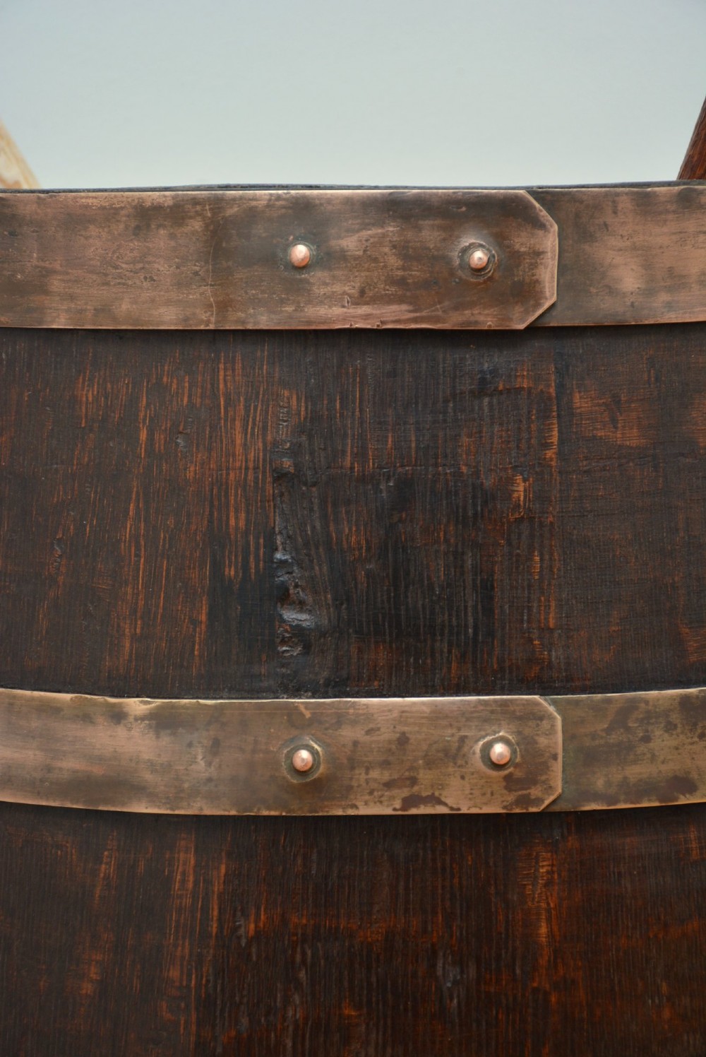 A Victorian dark oak coopered barrel umbrella stand with polished metal binding hoops. View IX