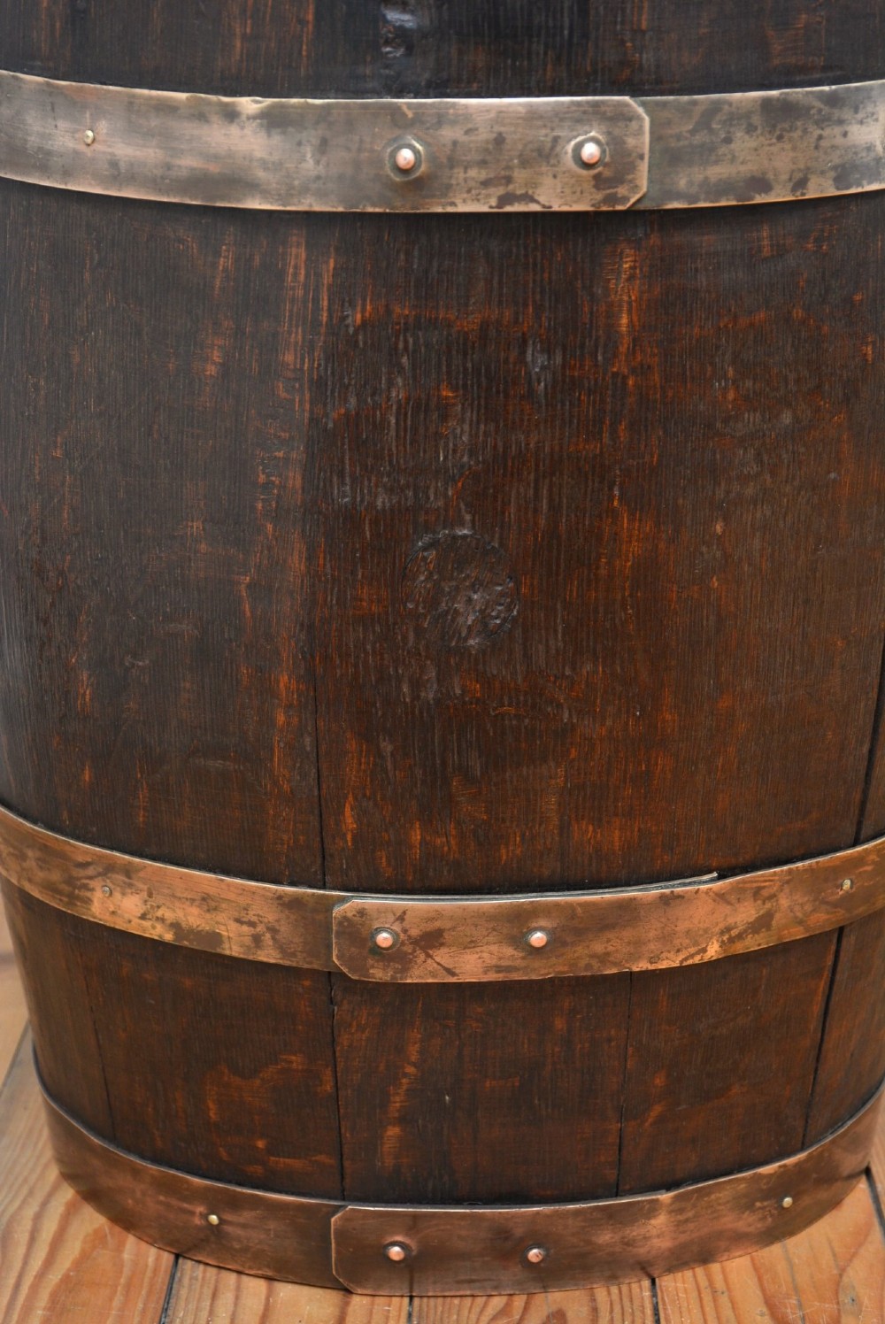 A Victorian dark oak coopered barrel umbrella stand with polished metal binding hoops. View X