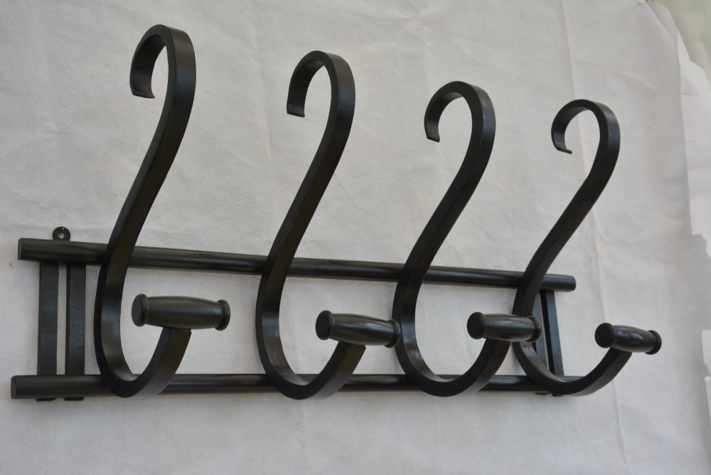 An ebonised bentwood wall-mounted coat rack featuring four large S-curved hooks mounted on a horizontal wooden backing rail. View II