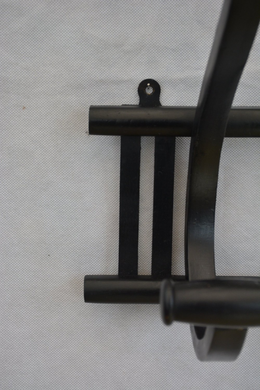 An ebonised bentwood wall-mounted coat rack featuring four large S-curved hooks mounted on a horizontal wooden backing rail. View VIII