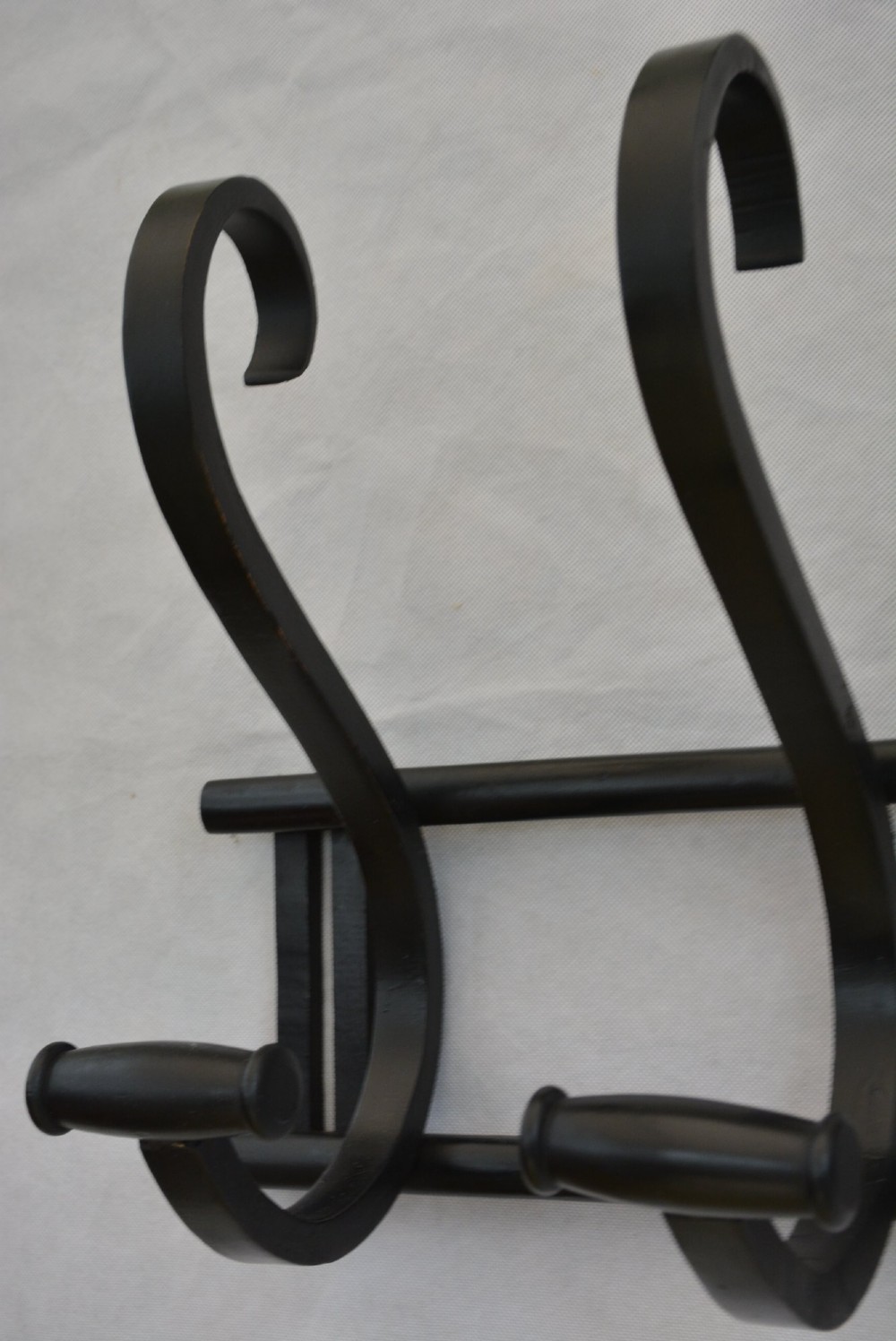 An ebonised bentwood wall-mounted coat rack featuring four large S-curved hooks mounted on a horizontal wooden backing rail. View XIV
