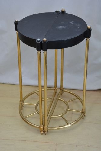 A pair of early 20th-century semi-circular brass umbrella stands with finial posts and black cast iron drip trays, placed back to back. View VII