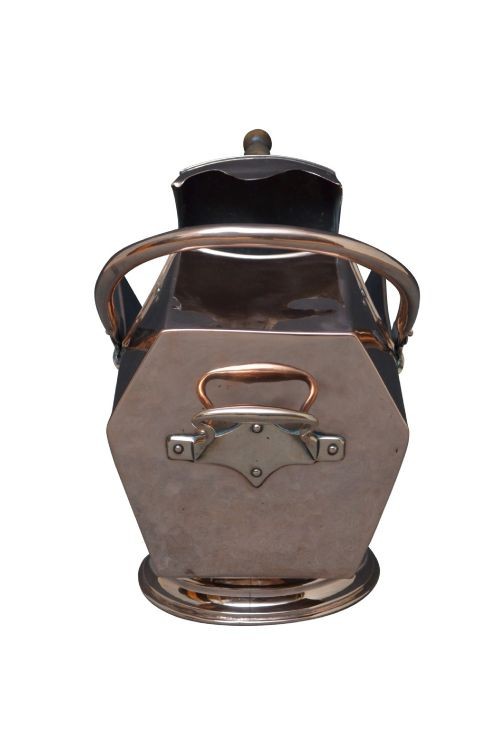 A copper coal helmet scuttle with a fixed overhead swing handle, riveted construction, and an integrated shovel with a turned wooden handle. View IV