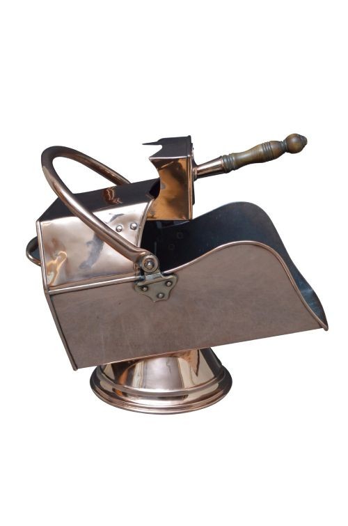 A copper coal helmet scuttle with a fixed overhead swing handle, riveted construction, and an integrated shovel with a turned wooden handle. View VI