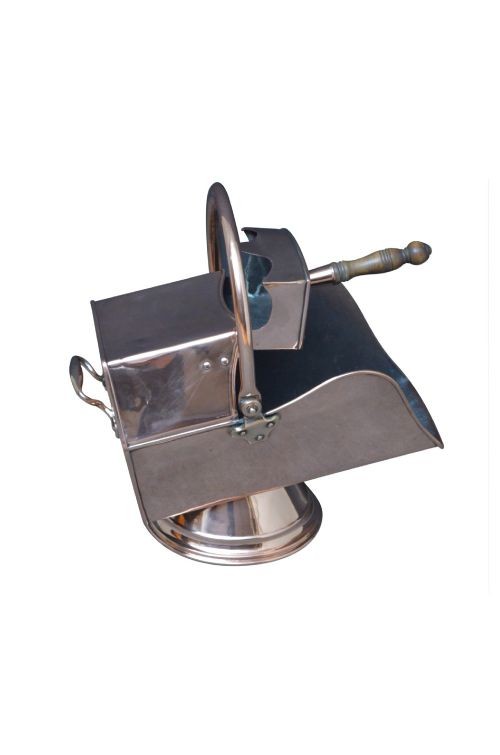 A copper coal helmet scuttle with a fixed overhead swing handle, riveted construction, and an integrated shovel with a turned wooden handle.