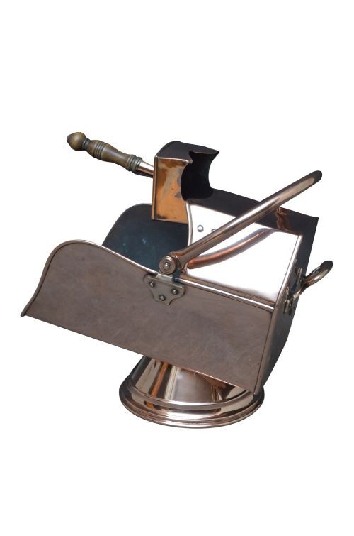 A copper coal helmet scuttle with a fixed overhead swing handle, riveted construction, and an integrated shovel with a turned wooden handle. View IX
