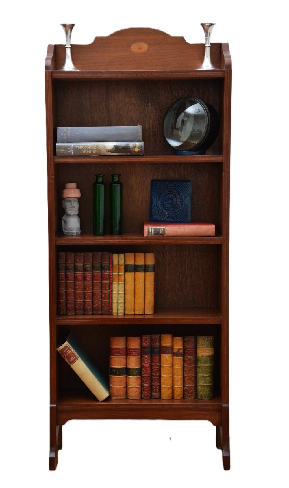A slim Edwardian mahogany open bookcase featuring four shelves, an inlaid oval motif on the shaped gallery top, and bracket feet. View XII