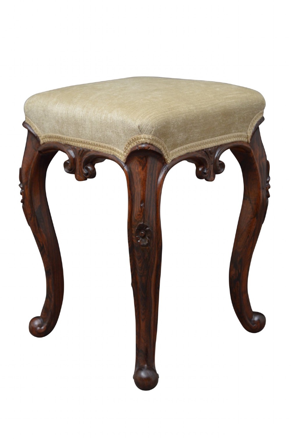 An antique carved dark rosewood stool featuring cabriole legs and a neutral upholstered padded seat.