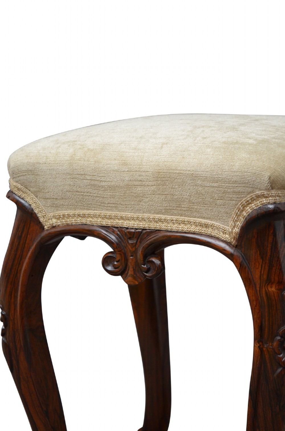 An antique carved dark rosewood stool featuring cabriole legs and a neutral upholstered padded seat. View V