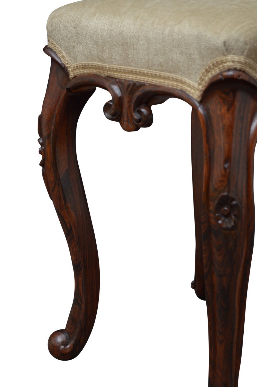 An antique carved dark rosewood stool featuring cabriole legs and a neutral upholstered padded seat. View VII