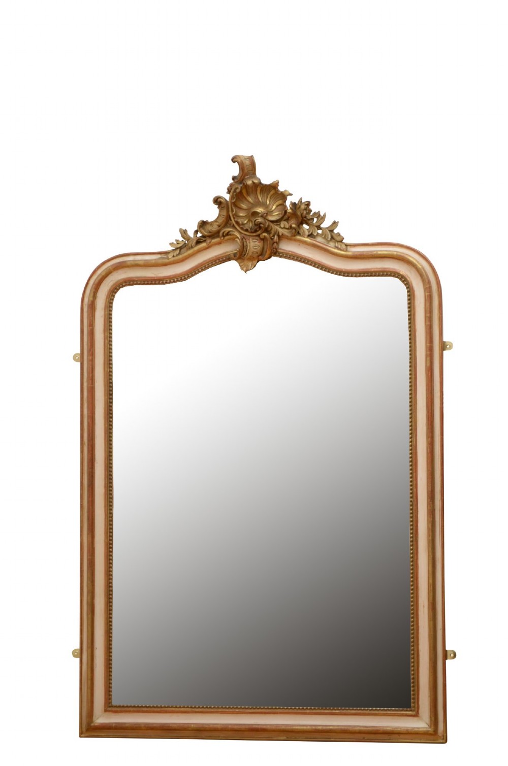 An arched French Chateau style wall mirror featuring a gilded wooden frame topped with a decorative carved shell crest.