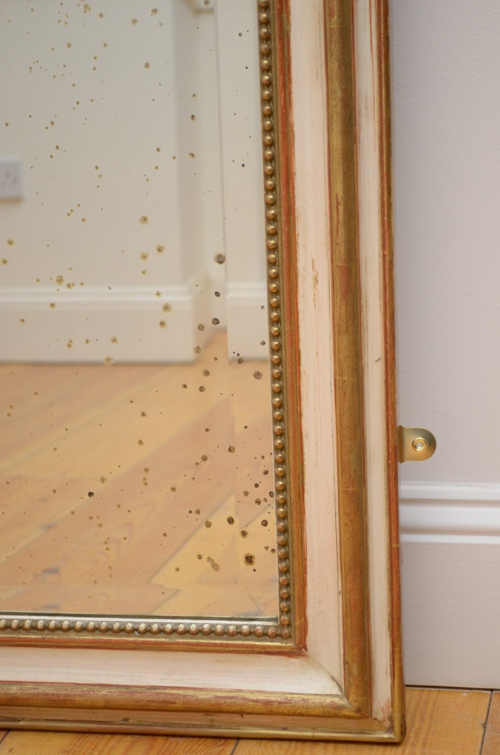 An arched French Chateau style wall mirror featuring a gilded wooden frame topped with a decorative carved shell crest. View XII
