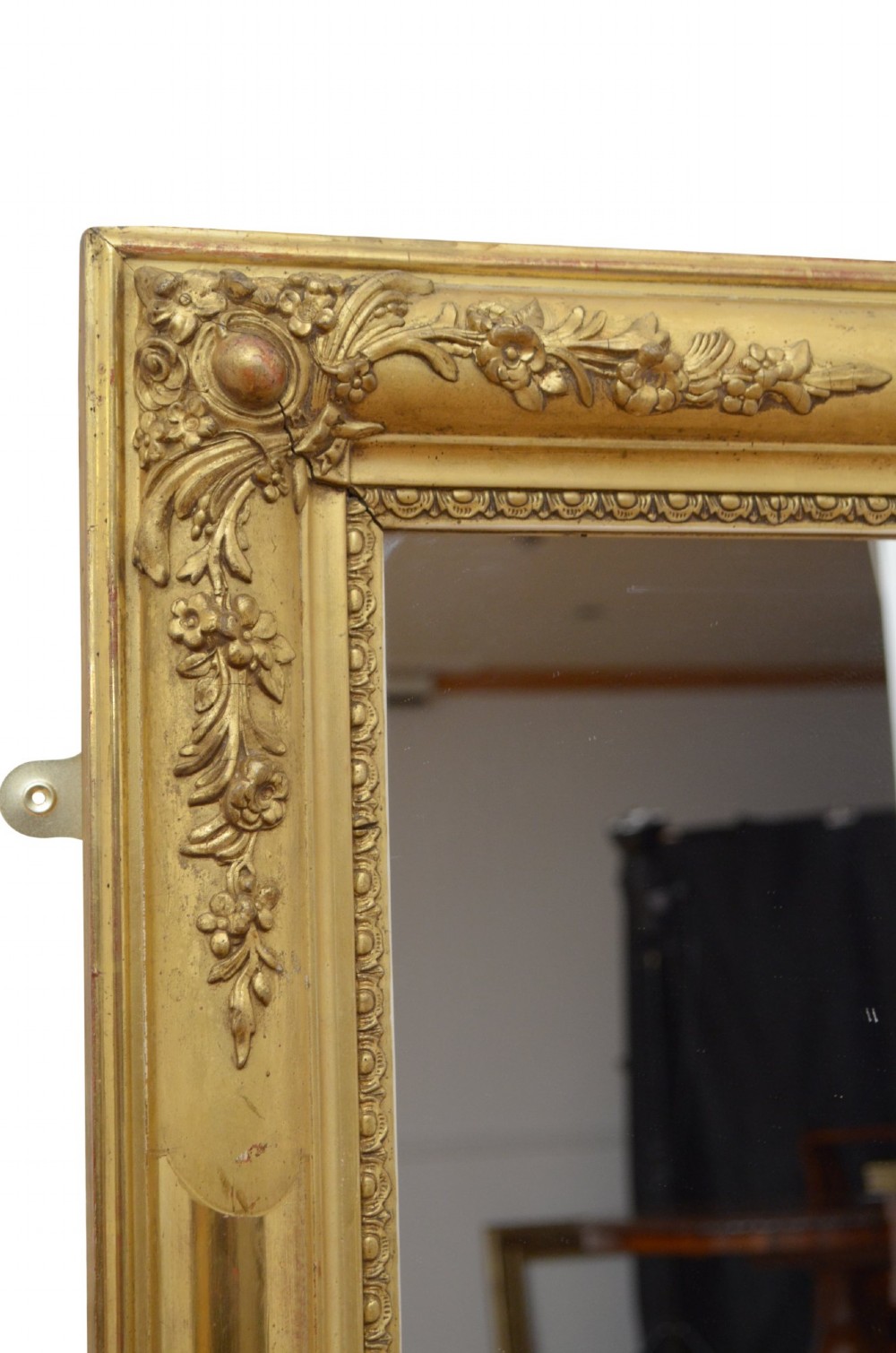A large rectangular antique giltwood wall mirror with carved floral corner details and a beaded inner border. View III
