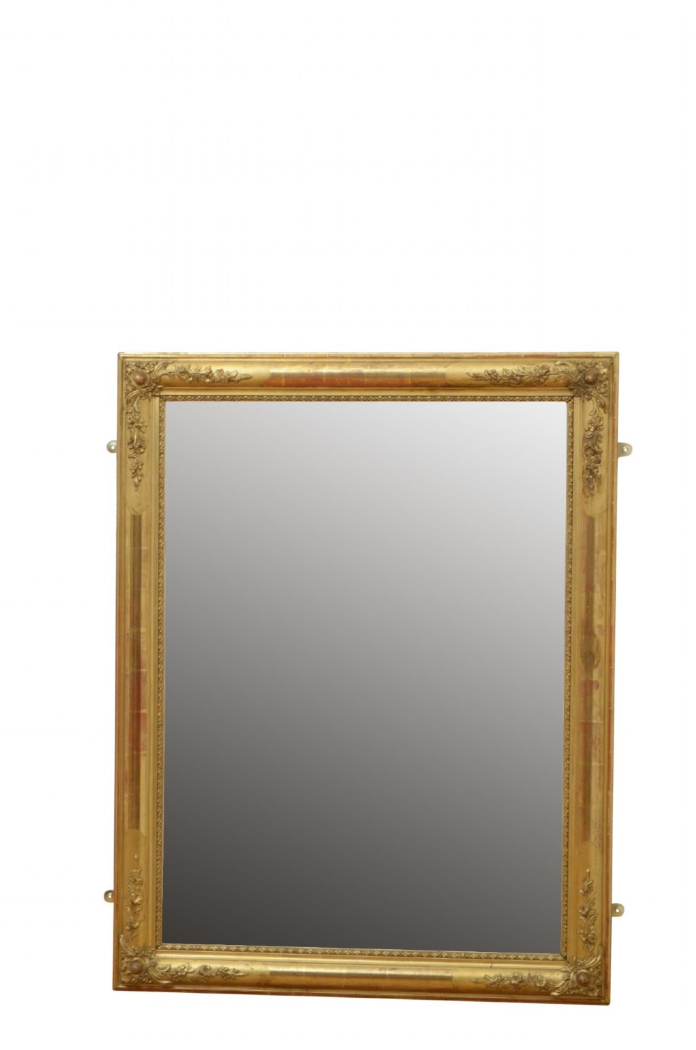 A large rectangular antique giltwood wall mirror with carved floral corner details and a beaded inner border. View IX