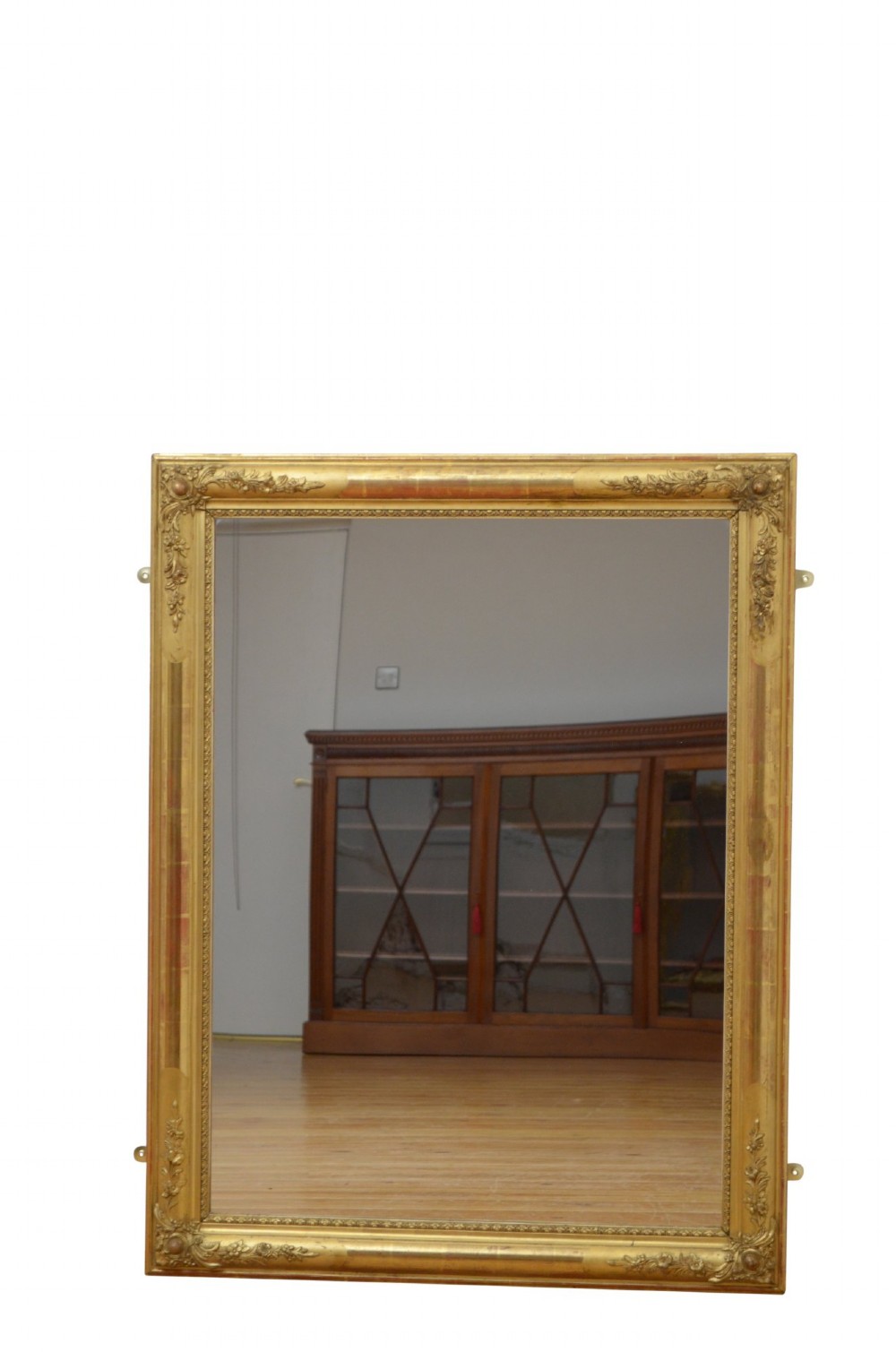 A large rectangular antique giltwood wall mirror with carved floral corner details and a beaded inner border. View X